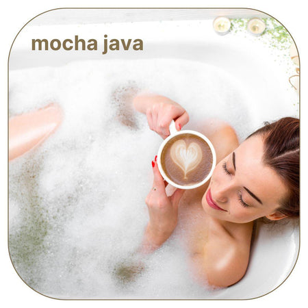 A beautiful smiling woman taking a bubble bath while drinking coffee with a heart shape. Caption reads: "Mocha Java."